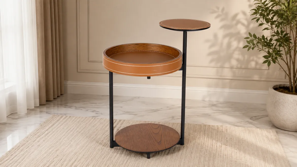 A two-tier tan side table beside a curtain